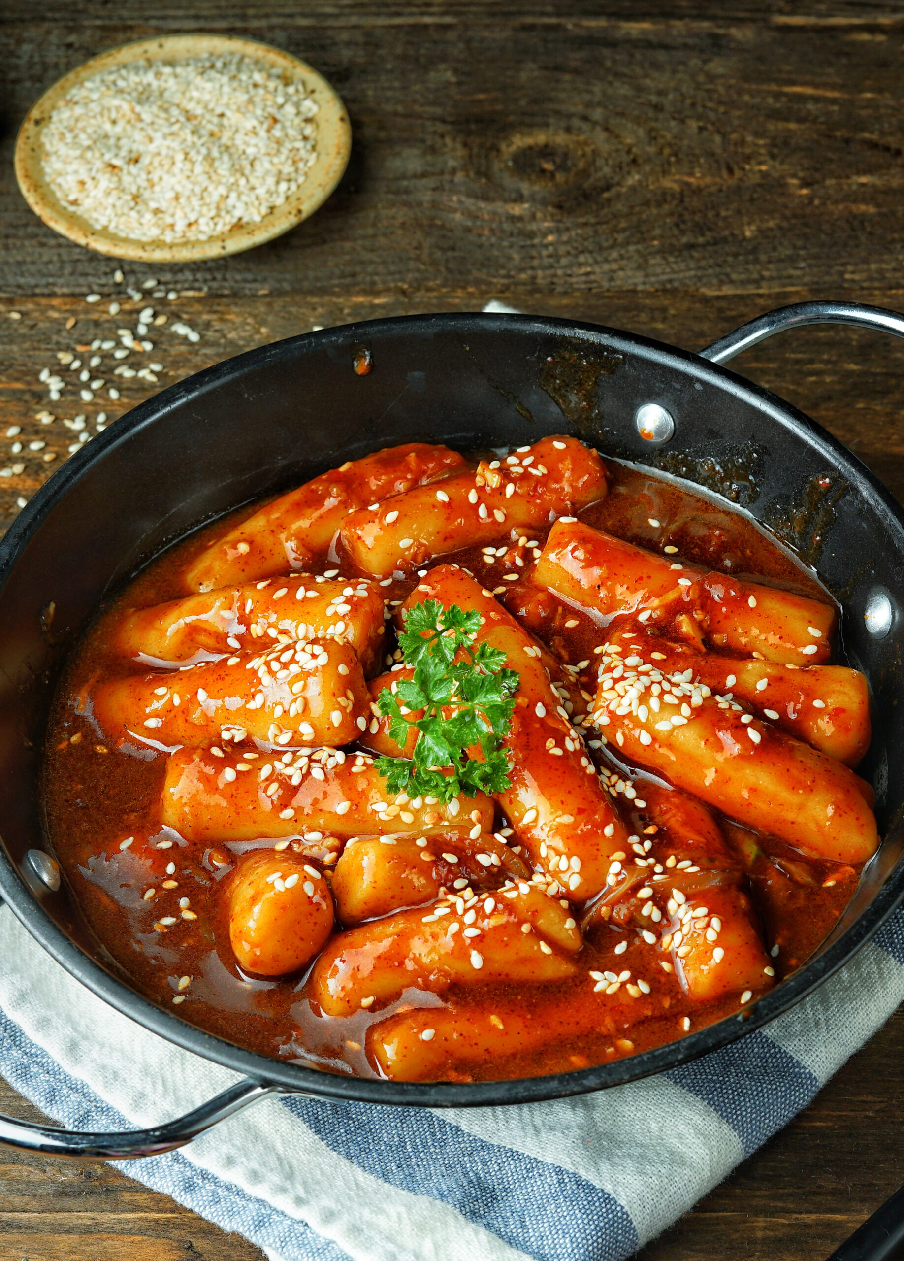 Close-up A plate of tteok-bokki, stir-fried rice cake is a popular Korean dish.  Spicy soup with added gochujang.  Sprinkle with roasted sesame seeds.